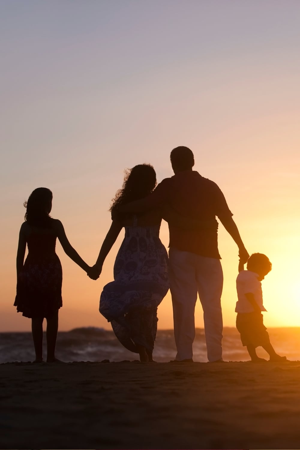 family watching sunset together during summer