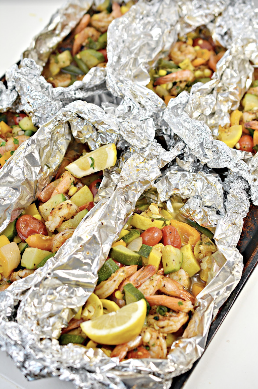 You'll love this flavorful, easy to make Shrimp and Veggie Foil Packs recipe - perfect for a weeknight dinner or your next summer cookout! #sidedishes #foilpacks #foilpackets #shrimprecipe #shrimpandveggies #summershrimp #summercookouts #dinner #lunch #summerbbq #bbq #easyrecipes #yummy #meltinmymouth #hipmamasplace