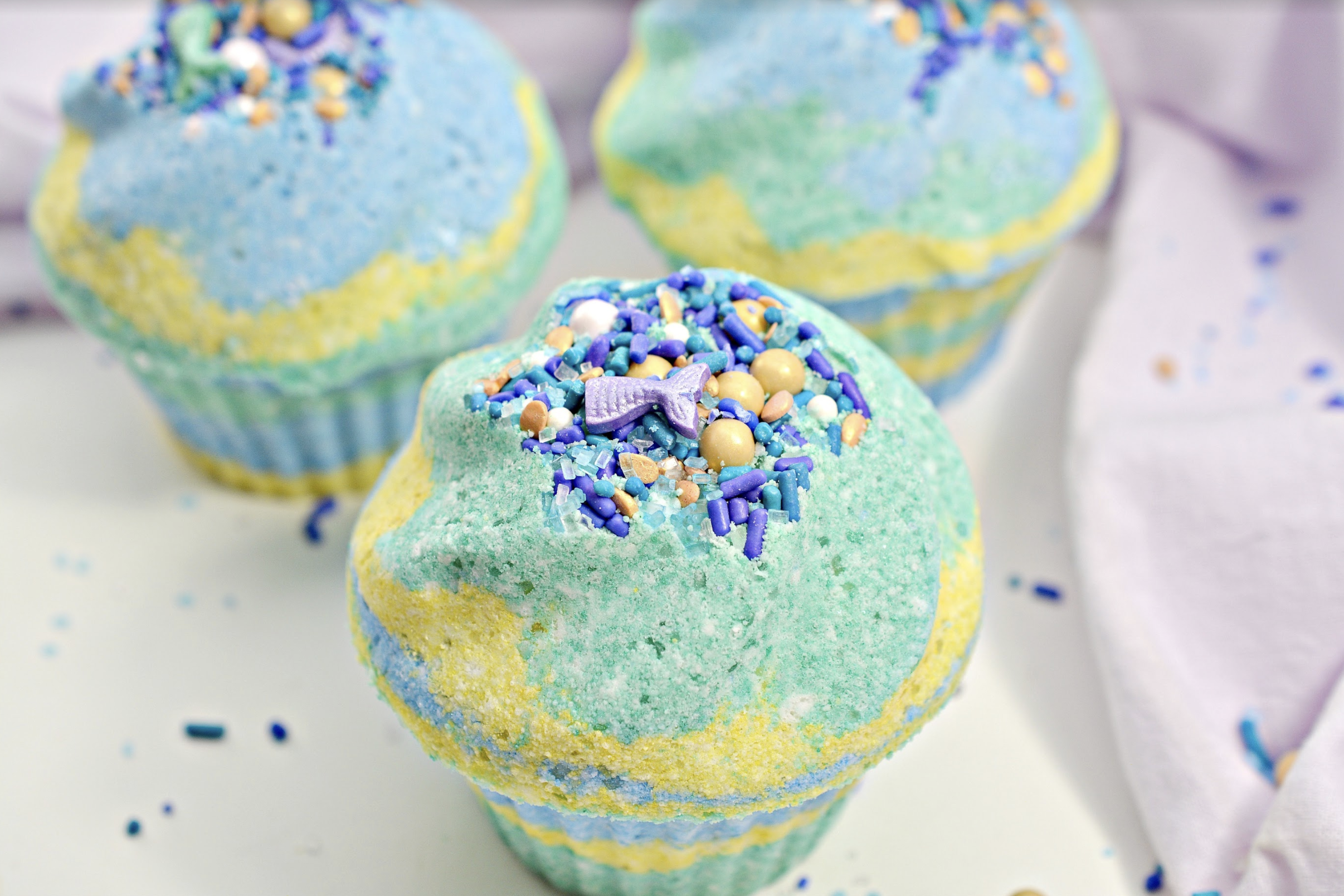 Make your next bath smell wonderful, fizzy and more relaxing with DIY bath bombs! Try my recipe for Mermaid Cupcake Bath Bombs DIY! #bathbombs #DIY #bathcare #selfcare #DIYbathbombs #homemade #homemadebathbombs #beauty #beautyrecipes #skincarerecipes #imadethis #beautybloggers #beautyinfluencer #crafty #craftymoms