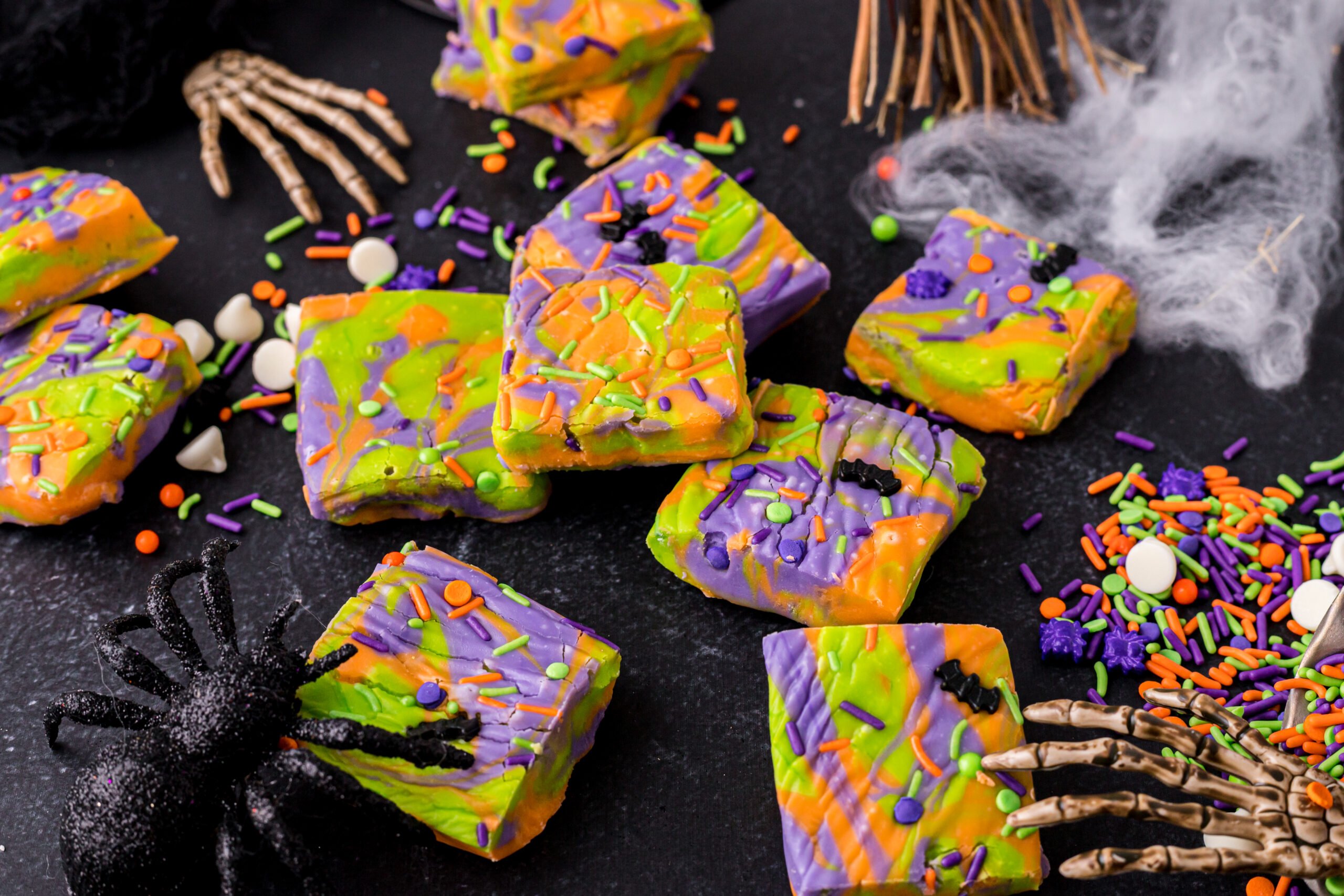 white chocolate fudge bars colored green purple and orange on a Halloween table