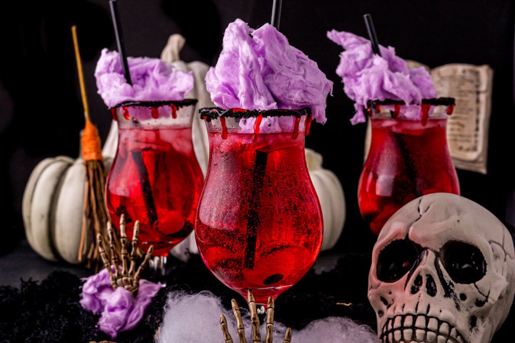 three glasses of vampire blood drink and a skull on the right side
