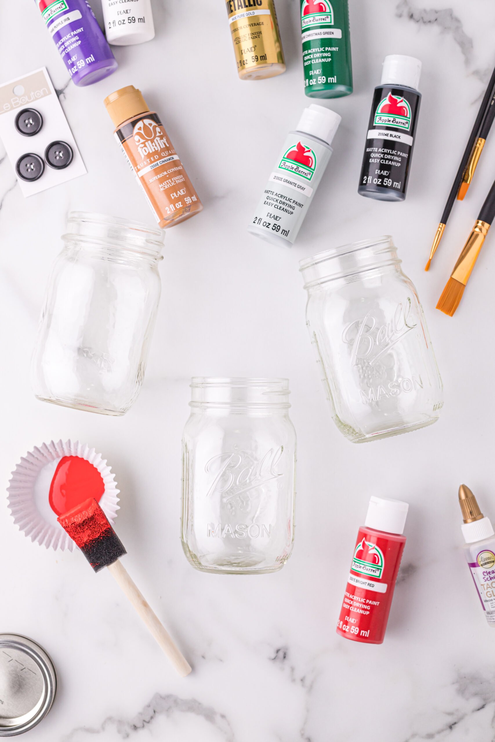 Paint, paintbrushes, and mason jars. 