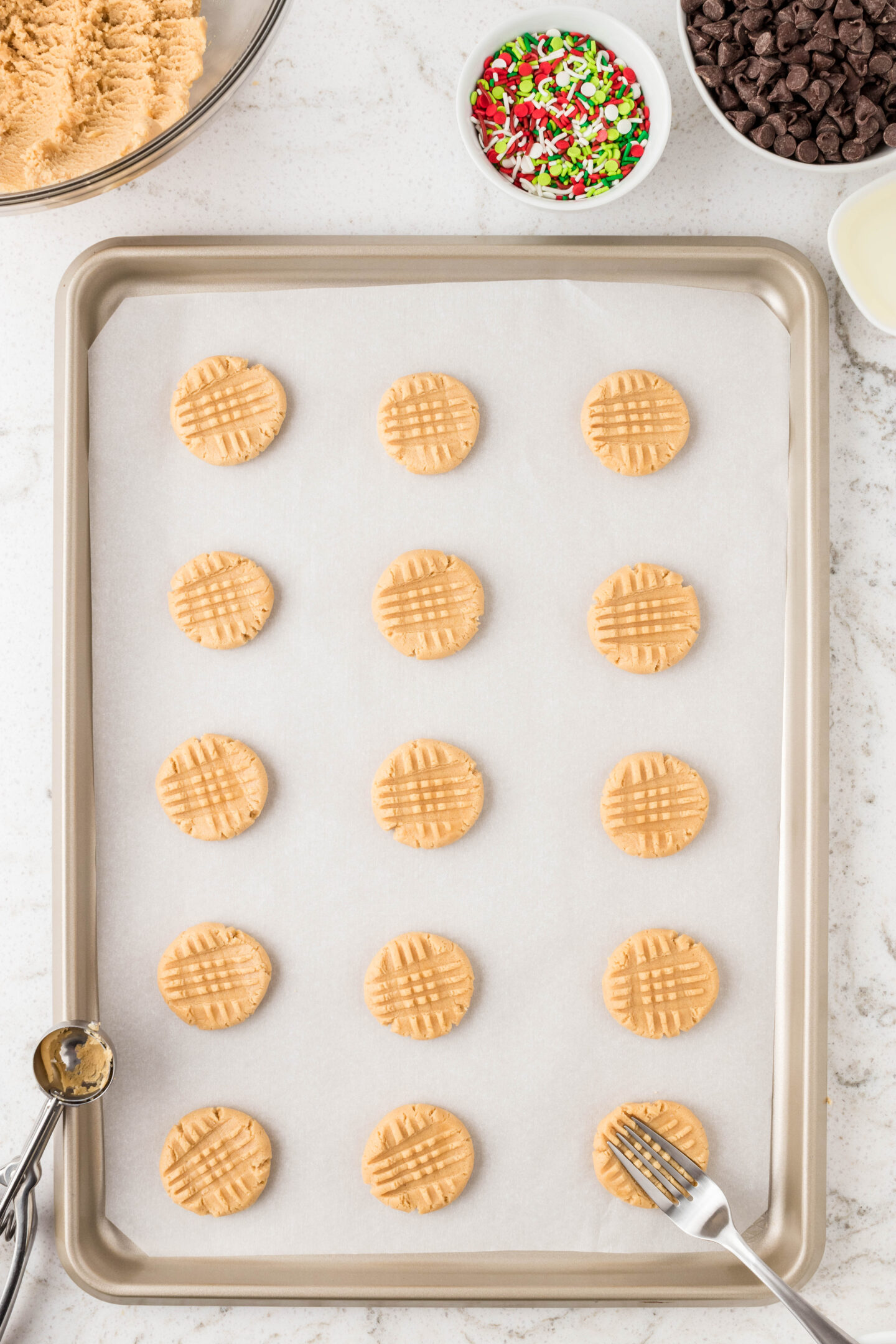peanut butter cookies on a baking sheet. 