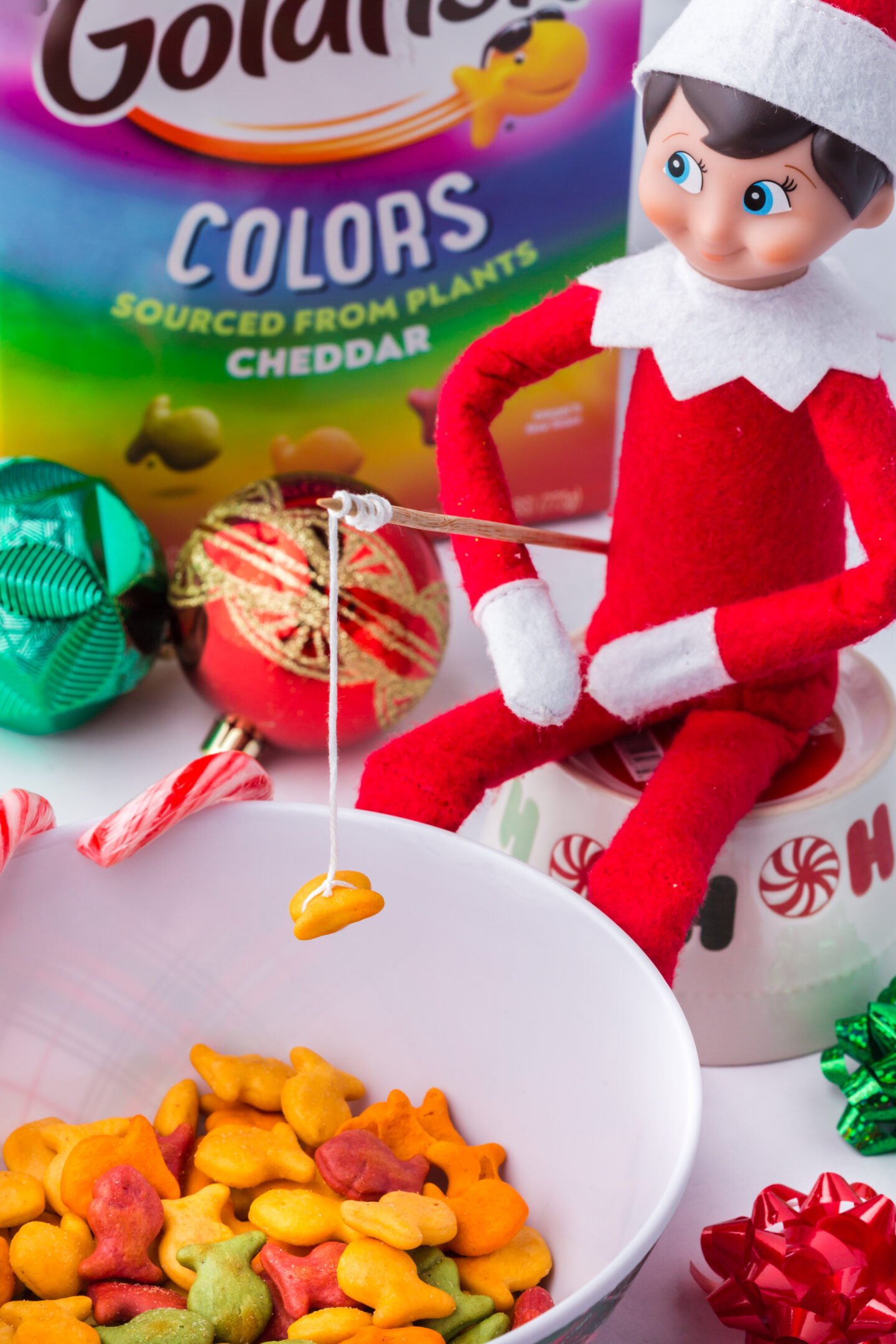 Elf on the Shelf fishing for goldfish crackers
