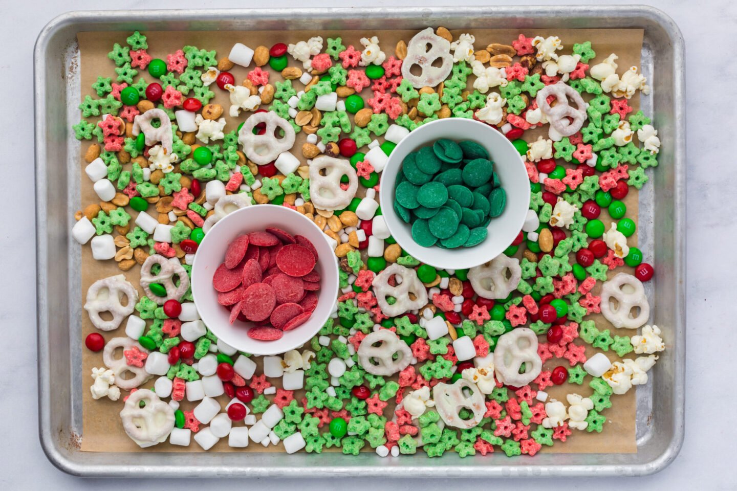red and green candy wafers in small bowls for Elf on the Shelf snack mix