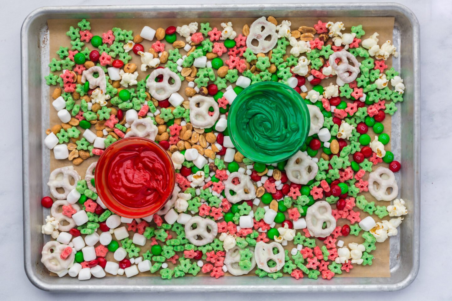 Melting red and green candy wafers for Elf on the Shelf snack mix drizzle