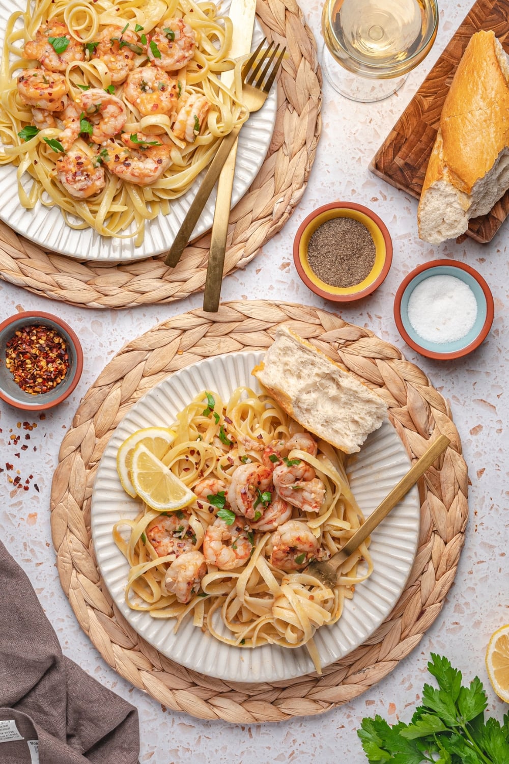 garlic butter shrimp served over pasta with lemon and parsley