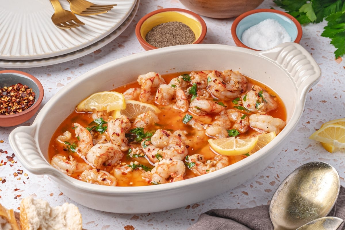garlic butter shrimp recipe in skillet with lemon and parsley