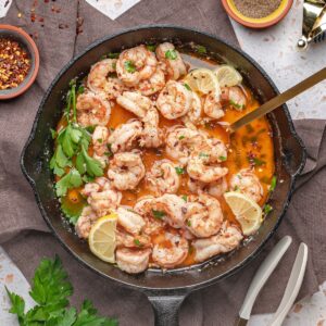 garlic butter shrimp recipe in skillet with lemon and parsley