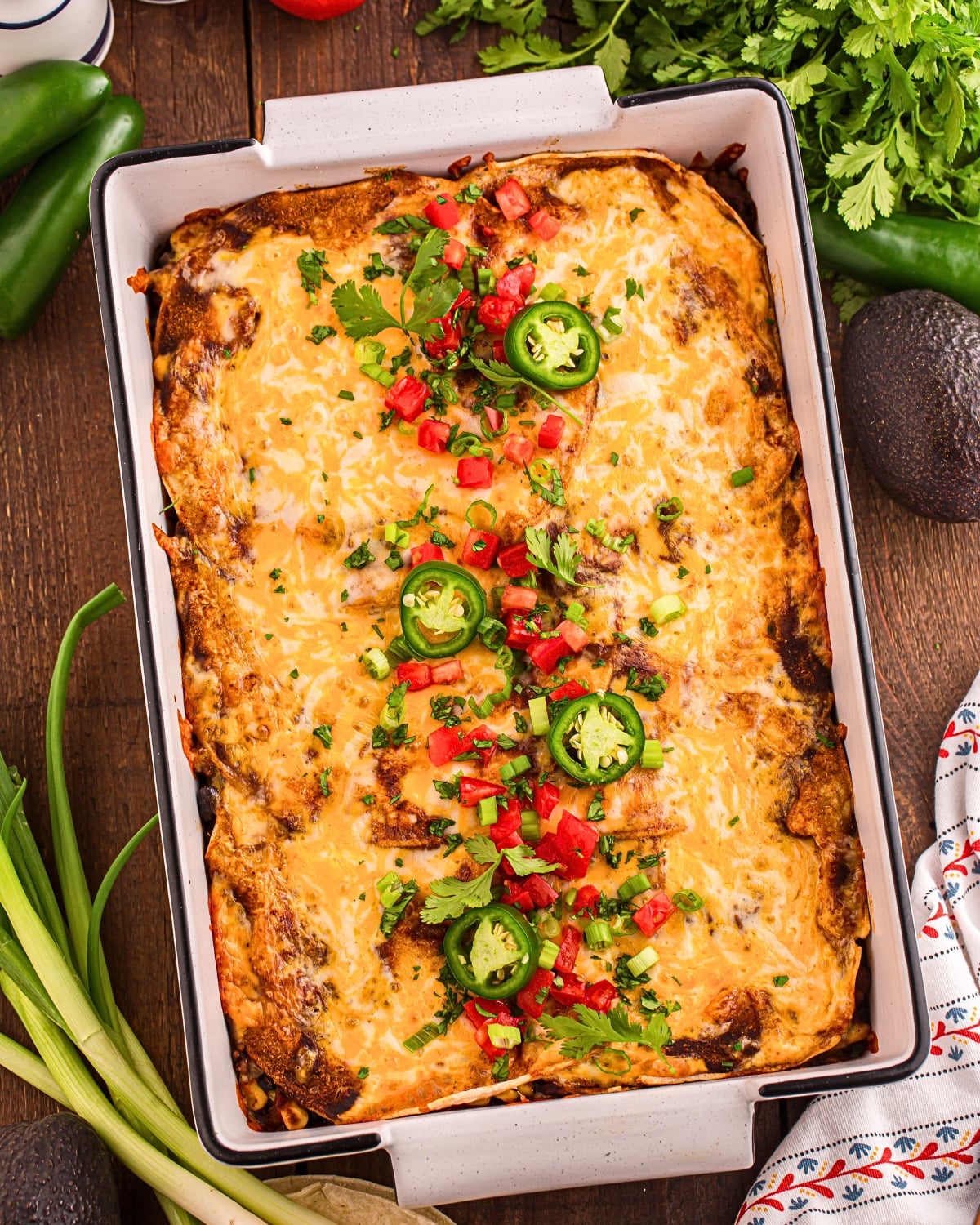 Mexican casserole served at family dinner table with toppings and sides