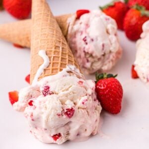 No churn strawberry ice cream in a loaf pan topped with fresh strawberries, creamy homemade strawberry ice cream without an ice cream maker