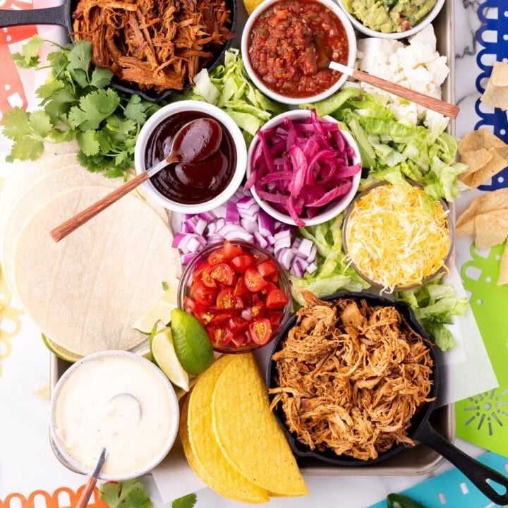 Ultimate taco board with seasoned beef, fresh toppings, tortillas, and colorful taco fixings arranged for an easy family taco night or party spread