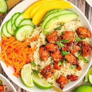 Crispy Air Fryer Salmon Bites coated in a sweet honey soy glaze and topped with sesame seeds and green onions.