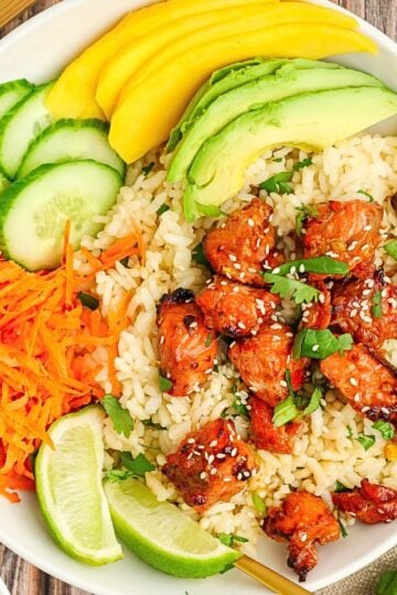 Crispy Air Fryer Salmon Bites coated in a sweet honey soy glaze and topped with sesame seeds and green onions.