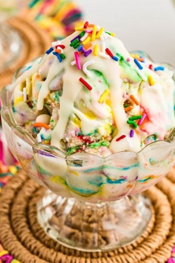 Cake Batter Ice Cream with Magic Shell served in a glass dessert bowl and loaf pan with rainbow sprinkles. A creamy homemade funfetti ice cream recipe and colorful summer dessert perfect for birthdays, celebrations, and family gatherings.