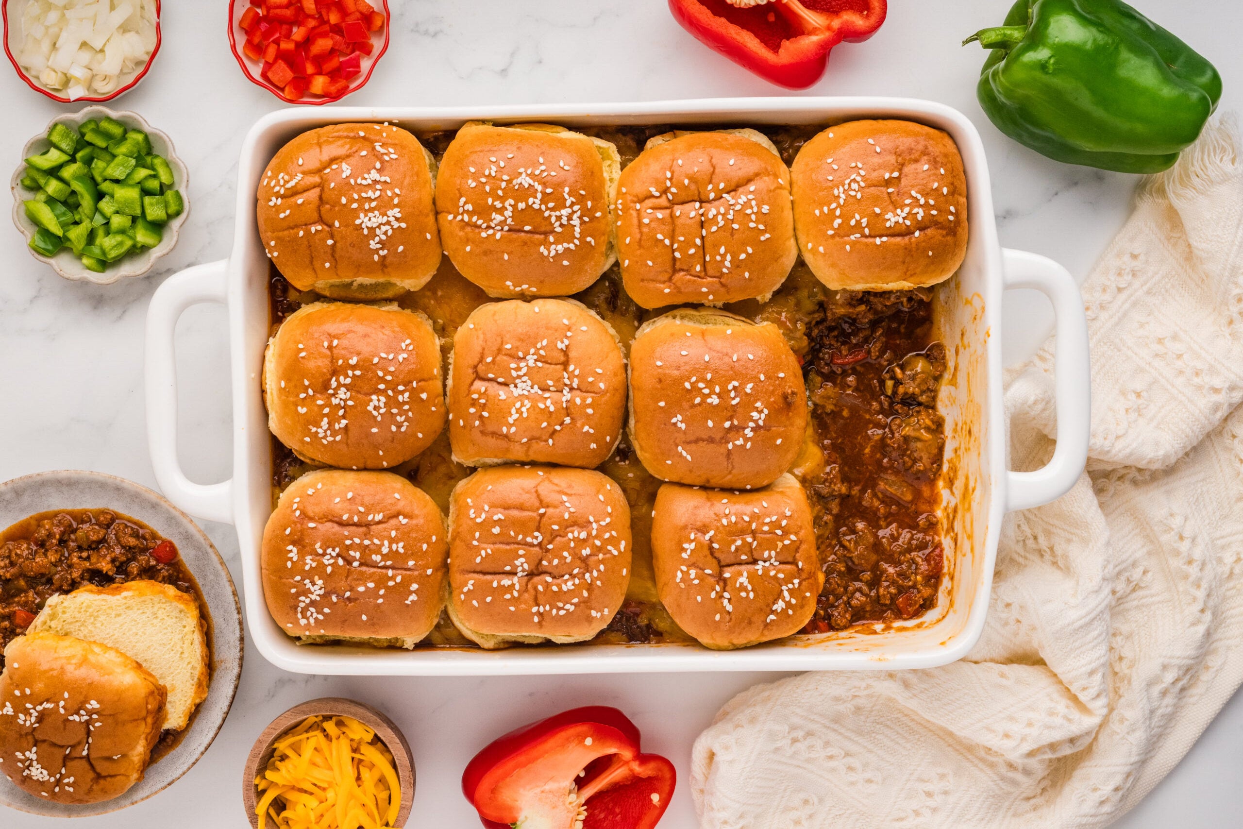 Finished baked Sloppy Joe casserole topped with golden buttery sesame slider buns
