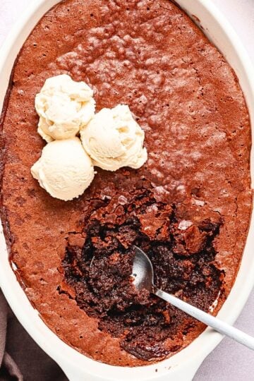 Warm Ina Garten brownie pudding with a crackly chocolate top and gooey center served with vanilla ice cream