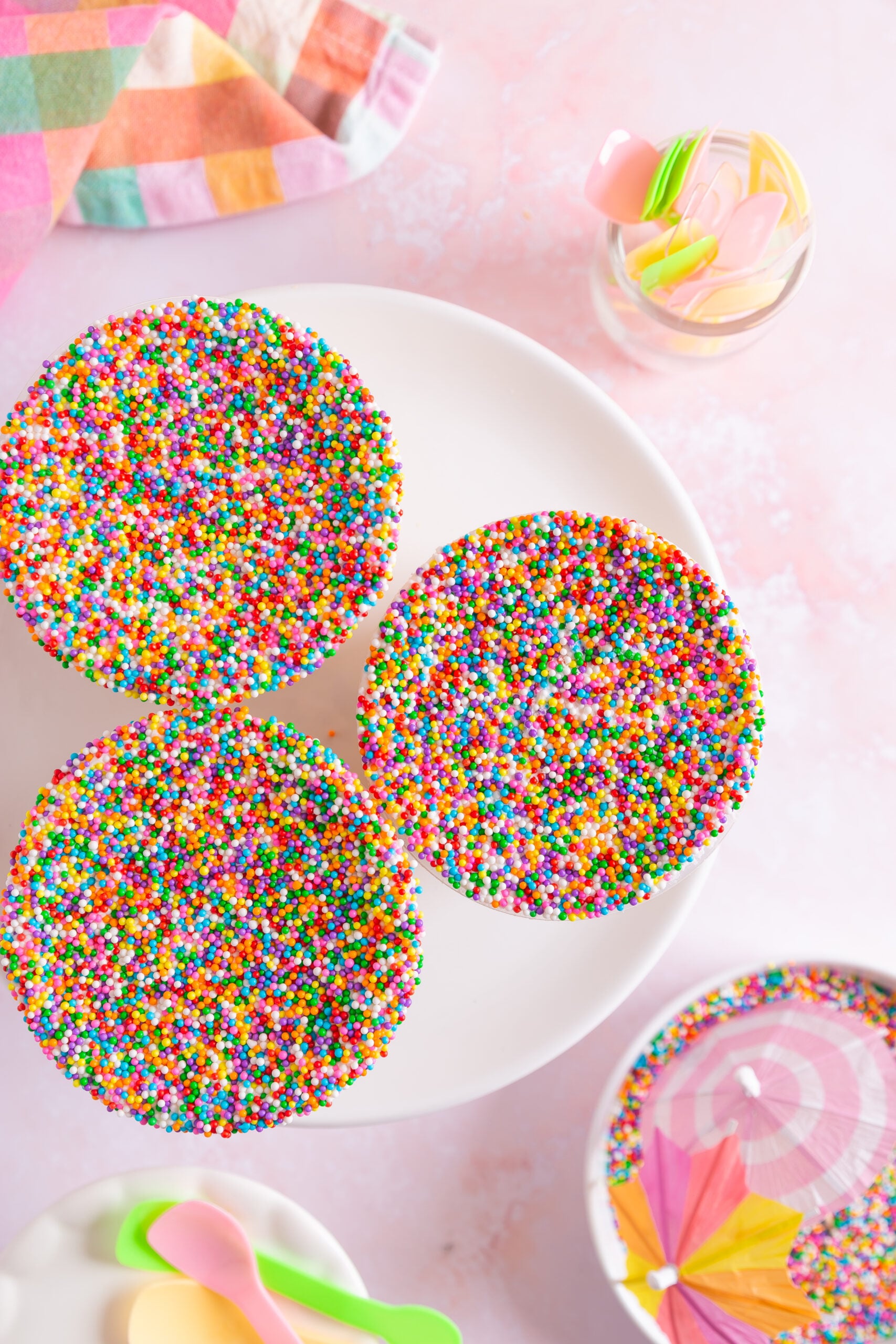 Viral dot cake recipe with layered vanilla cake, buttercream and rainbow nonpareils in clear cups